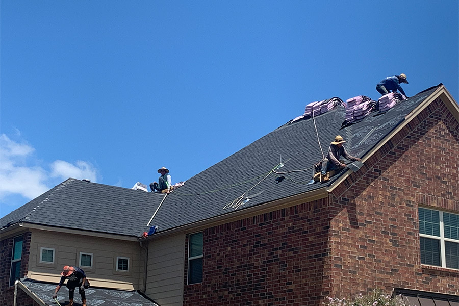 contractors installing new asphalt shingles roof at residential property converse-tx
