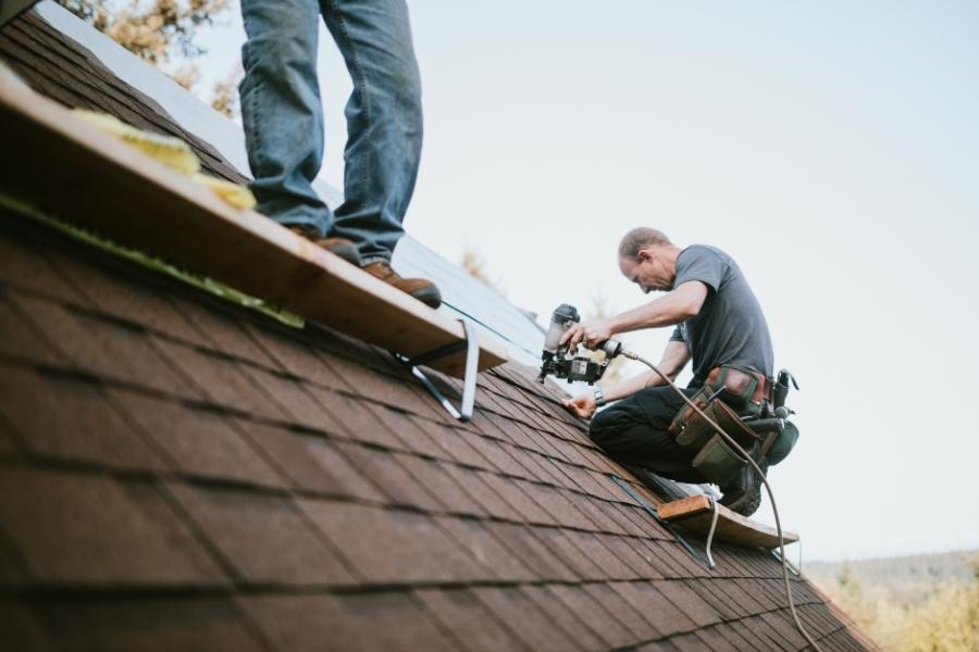 contractors on top of house roof repairing asphalt shingles new braunfels tx